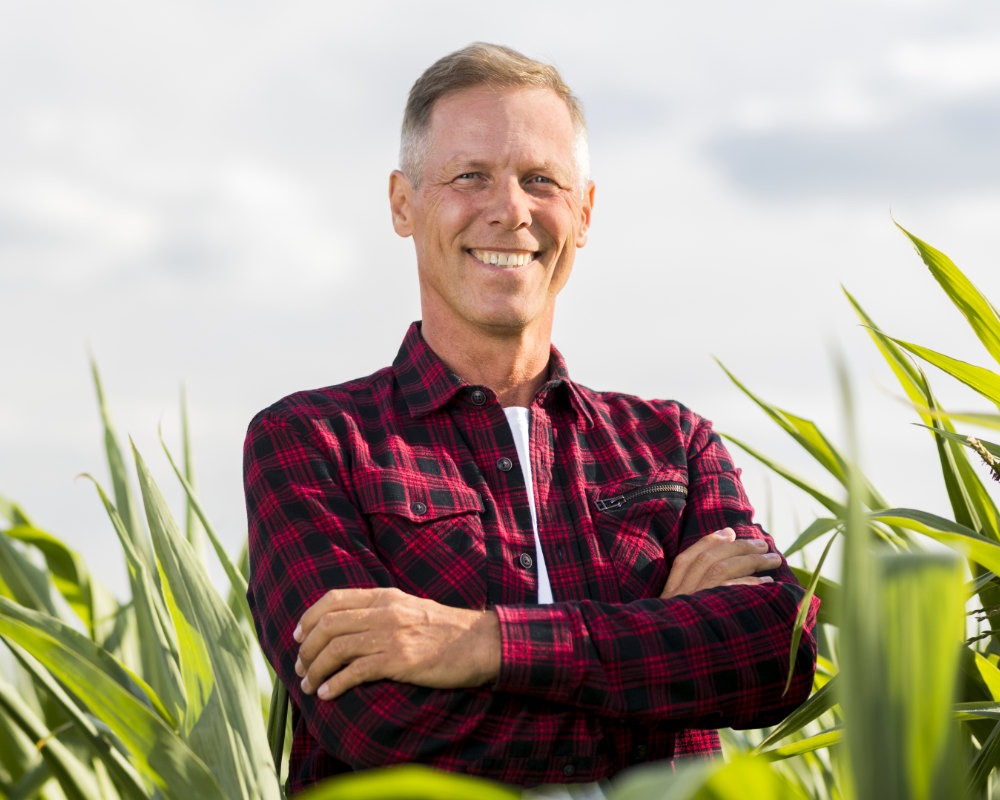 Happy man standing in field